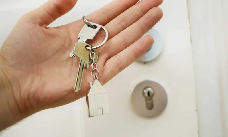 Hand holding keys to their new home
